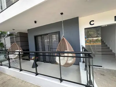 a balcony of a house with two hanging baskets at Residenza in Santiago de los Caballeros
