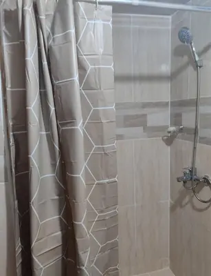 a shower with a glass door in a bathroom at Habitación con baño privado y otras áreas compartidas in San Luis