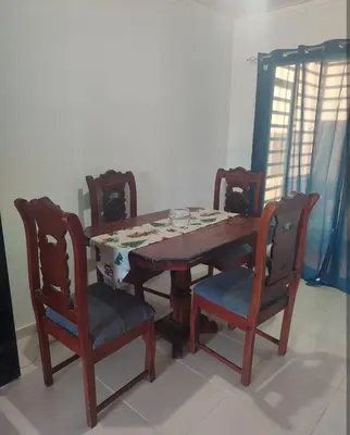 a dining room table with four chairs and a table and chairsuggest at Habitación con baño privado y otras áreas compartidas in San Luis