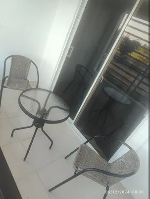 a glass table and chairs in a room at Habitación con baño privado y otras áreas compartidas in San Luis
