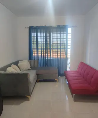 a living room with two couches and a red couch at Habitación con baño privado y otras áreas compartidas in San Luis