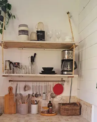 a kitchen with wooden shelves and utensils at Beach Bungalow 100 m Playa Coson in Las Terrenas