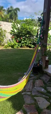 a colorful hammock sitting in a yard at Beach Bungalow 100 m Playa Coson in Las Terrenas
