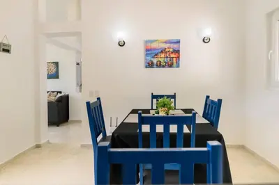 a dining room with a blue table and chairs at Casa Jobo Scenic ViewsPrivate Pool TablePool in San Felipe de Puerto Plata