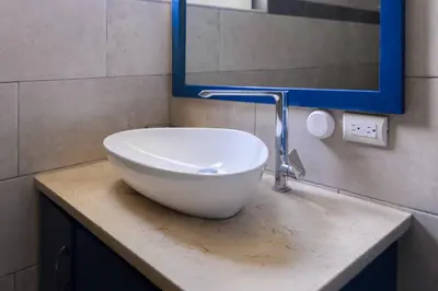 a bathroom with a white bowl sink on a counter at Casa Jobo Scenic ViewsPrivate Pool TablePool in San Felipe de Puerto Plata