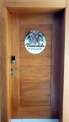 a wooden door with a sign on it at Backup Power 2BR 2BA AC WiFi Gym 24h Security Ideal for long stays in Santiago de los Caballeros