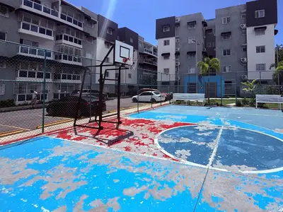 an empty basketball hoop in a parking lot at Mi casa es tu casa in Santo Domingo