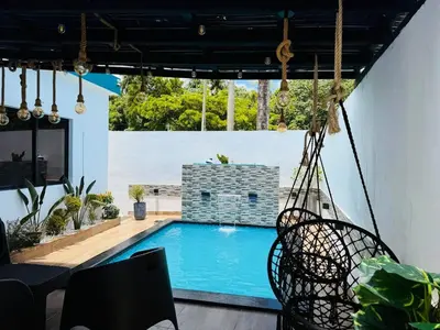 a swing over a swimming pool in a house at Tropical Escape Villa in Puerto Plata