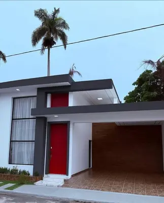 a house with a red door and a palm tree at Tropical Escape Villa in Puerto Plata