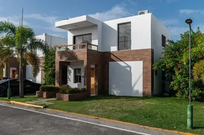 a house on the side of a street at Hermosa villa con piscina privada, jacuzzi y playas cercanas in Punta Cana