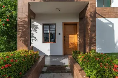 a front door of a house with flowers at Hermosa villa con piscina privada, jacuzzi y playas cercanas in Punta Cana