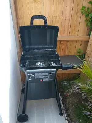 a bbq grill sitting outside in a garden at Hermosa villa con piscina privada, jacuzzi y playas cercanas in Punta Cana