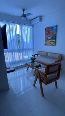 a living room with a couch and a table at Mar, Sol y Arena in Paraíso