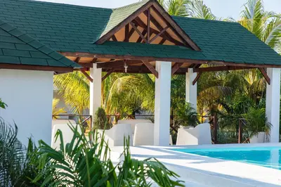 a gazebo with chairs and a swimming pool at LAS PALMAS 2 VILLA 20 personnes pool in Palmar de Ocoa