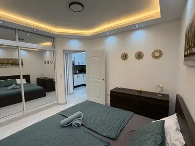 a bedroom with a large bed and a mirror at Luxury NEW Stylish apartment Bayahibe with pool in Bayahibe