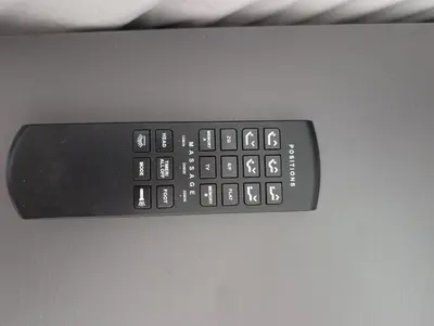 a black remote control sitting on top of a desk at Hispanola Beach 3 Bdr Outdoor Jacuzzi in Sosúa