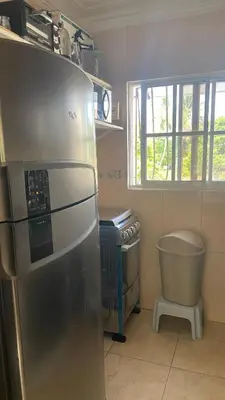 a kitchen with a stainless steel refrigerator and a window at A Few Steps to Malecon and Sunny Beaches in San Felipe de Puerto Plata