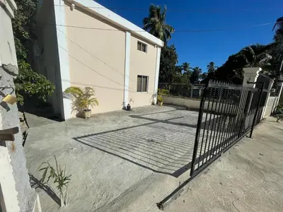 a gate in front of a white building at Lofts R&L in Juan de Herrera