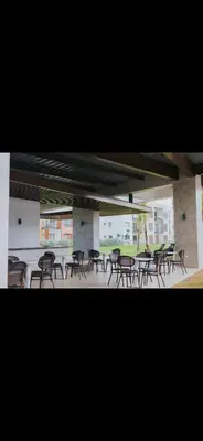 a group of chairs and tables in a building at Costa bávaro garden in Punta Cana