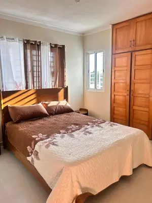 a bedroom with a large bed and wooden cabinets at Vista del sol in La Viva