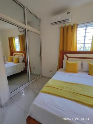 a bedroom with two beds and a large window at Apartament with Beautiful Mountain View in Puerto Plata