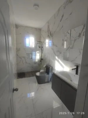 a white bathroom with a sink and a toilet at Apartament with Beautiful Mountain View in Puerto Plata