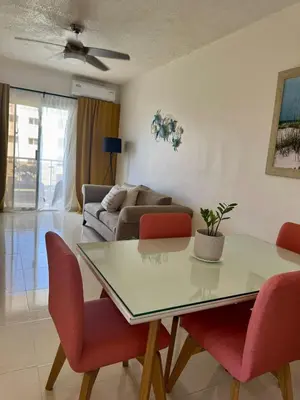a living room with a table and a couch at Bayahibe Apartment by the Beach in Bayahibe