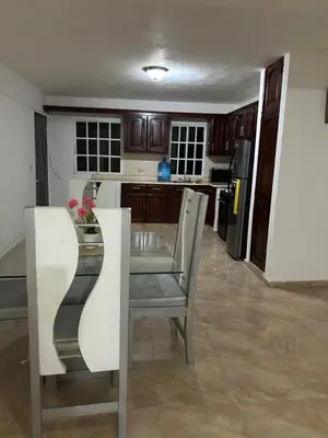 a kitchen with a table and chairs in a room at Villas Maniscalco in Camú