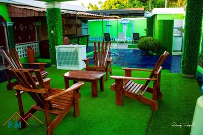 a group of chairs and a table on a lawn at Remanso de Paz in Pedernales