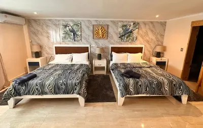 two beds sitting next to each other in a room at Noe hotel in Punta Cana