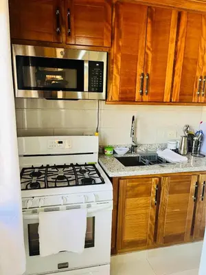 a kitchen with a white stove and a microwave at Brisas de Valle in Jarabacoa