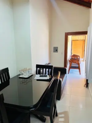 a dining room with a table and chairs and a couch at Brisas de Valle in Jarabacoa