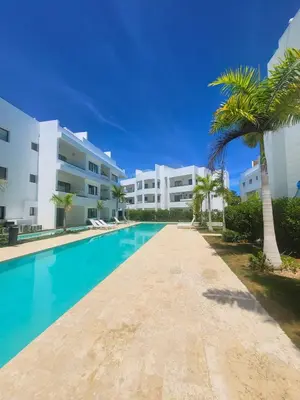 a swimming pool in front of a building at Ona Residences Punta Cana in Punta Cana
