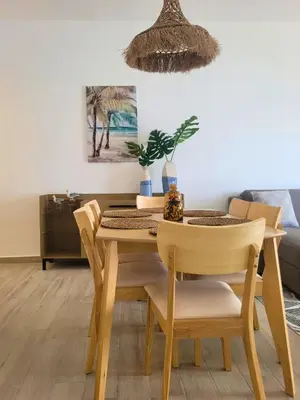 a dining room with a table and chairs at Ona Residences Punta Cana in Punta Cana