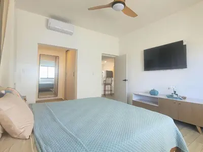 a bedroom with a bed and a ceiling fan at Ona Residences Punta Cana in Punta Cana