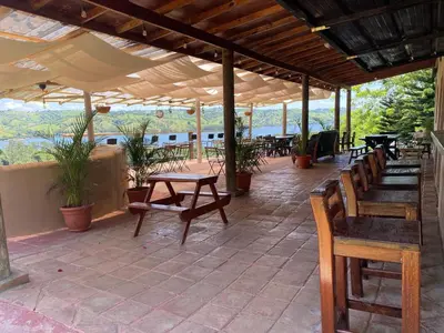 a covered patio with benches and tables and tables at Villas del lago resort in Colorado