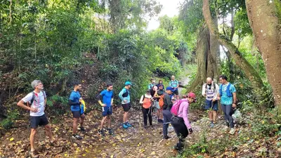 a group of people walking on a trail in the forest at Villas del lago resort in Colorado