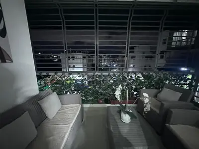 a living room with couches and a large window with plants at Elsa in Jacagua