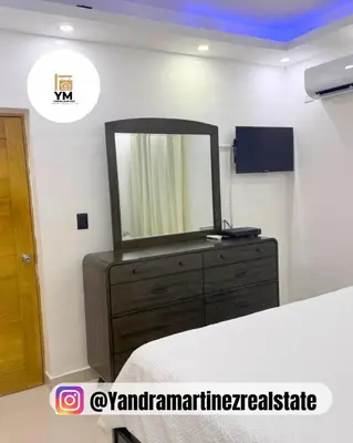 a bedroom with a dresser with a mirror on it at Ideal amueblado, céntrico y acogedor in Los Paredones
