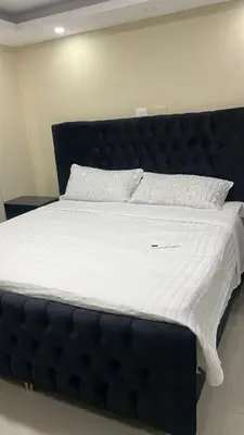 a large bed with a black headboard in a room at Villa La Perla in Pimentel
