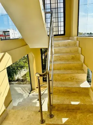 a staircase with a metal hand rail in a building at Apartamento en la romana residencial los García I in La Romana
