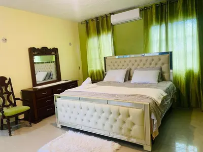 a bedroom with a large bed and a mirror at Paris London hause in Los Grini