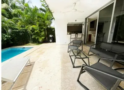 a patio with chairs and a swimming pool at Tropical VILLAGE in Las Terrenas
