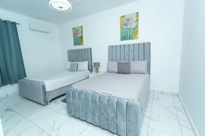 a bedroom with two beds and a bedskirts at Ventura Living in Nagua