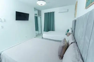 a living room with two beds and a couch at Ventura Living in Nagua