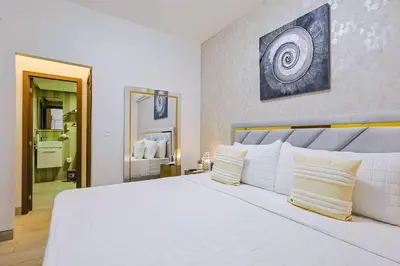 a bedroom with a large white bed with white pillows at Cozy 2BR Condo, Spectacular Rooftop in Santo Domingo