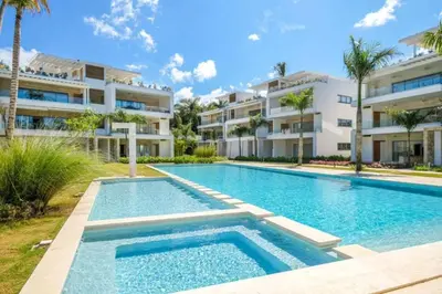 an image of a swimming pool in front of a building at Modern 2BD With Pool And Huge Private Terrace in Las Terrenas