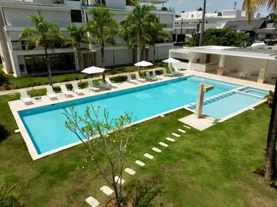 an overhead view of a swimming pool with chairs and a building at Modern 2BD With Pool And Huge Private Terrace in Las Terrenas