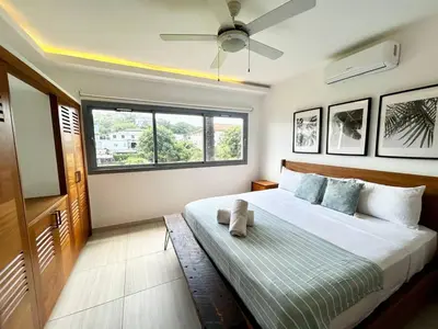 a bedroom with a bed with a ceiling fan at Modern 2BD With Pool And Huge Private Terrace in Las Terrenas
