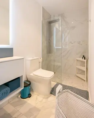 a bathroom with a toilet and a glass shower at Caribbean Heaven in Punta Cana